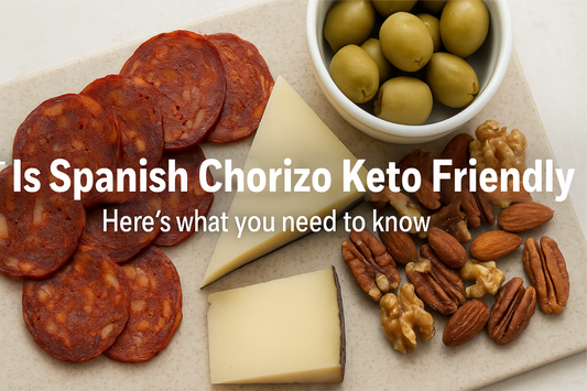 Overhead view of a keto charcuterie board featuring sliced Spanish chorizo, manchego cheese, olives, and almonds on a wooden board