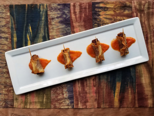 Tapas plate of potato-wrapped Aurelia's Snack Sticks and a romesco sauce.