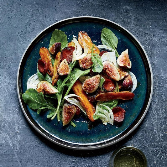 Salad plate filled with fresh figs, arugula and Spanish chorizo.