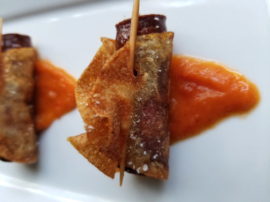 Tapas plate of potato-wrapped Aurelia's Snack Sticks and a romesco sauce.