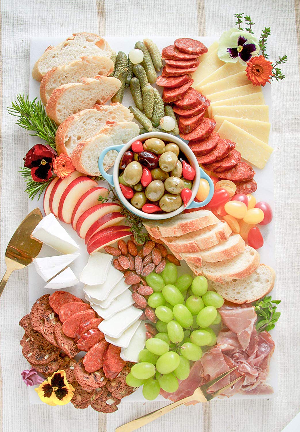 Charcuterie Board with slices of Spanish Chorizo, cheeses, apples and bread.