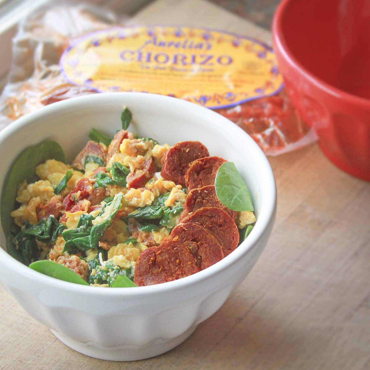 A protein bowl with eggs, spinach and slices of Spanish Chorizo.